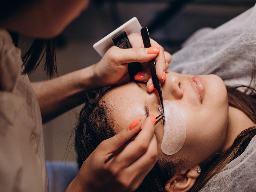 Lash technician performing a lash lift treatment on a client